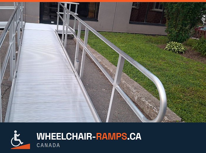 Close-up of a hand gripping a round ramp handrail